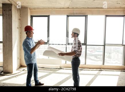 team of positive Caucasian engineers are having discussion at work. side view photo Stock Photo