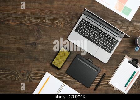 Flat layout of mobile gadgets, drink, open notebook with pencil and other stuff Stock Photo