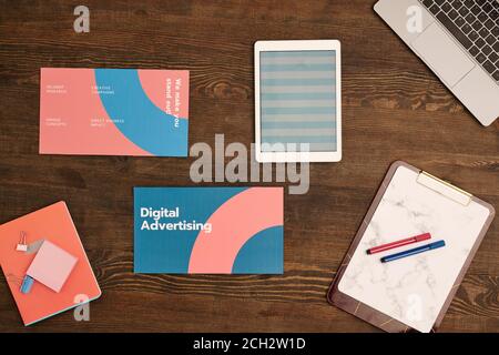 Top view of laptop keypad, digital tablet with striped pattern and documents Stock Photo