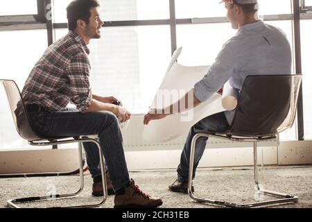 two construction workers are concentrated on the building project. side view photo Stock Photo