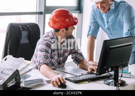 smiling electicians using computer at work. close up portrait Stock Photo
