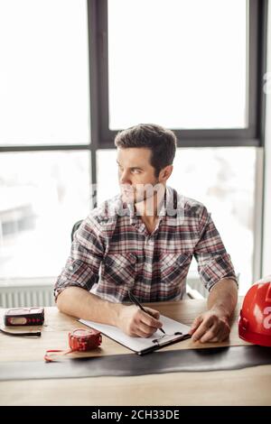 pensive architect working on blueprint in the office. creative man is thinking about work. close up photo Stock Photo