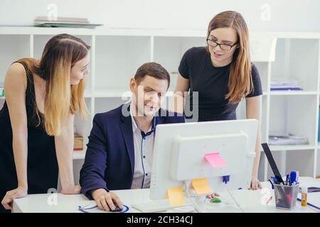 nice female asistants helping attractive chief in formal clothes with daily business. closeup portrait Stock Photo