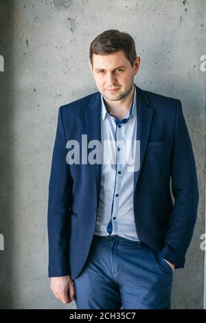 handsome office worker in nice suit looking at the camera at work Stock Photo