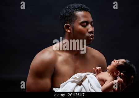 good father with his infant. ideal daddy.upbringing skills. man singing tio sleep. daddy putting baby to sleep, close up portrait. isolated on the bla Stock Photo