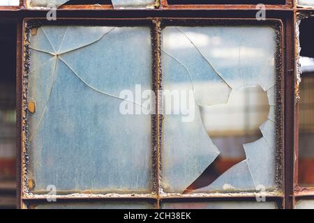 Old cracked and Broken Window in an industrial factory. Stock Photo