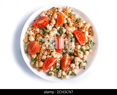 Vegetarian salad of boiled chickpeas, cheese, arugula, mustard and cherry tomatoes isolated on white background, top view. Stock Photo