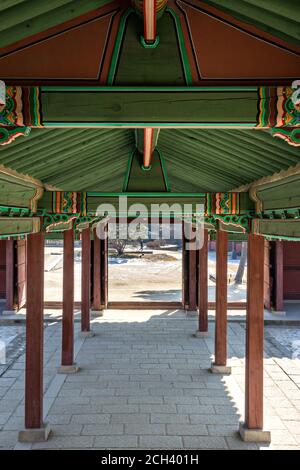 A covered walkway from the Seonjeongjeon Hall at the Changdeokgung Palace in Seoul, South Korea. The building was the main place for the emperor to meet with high ranking officials to discuss political, state, and foreign affairs. Stock Photo