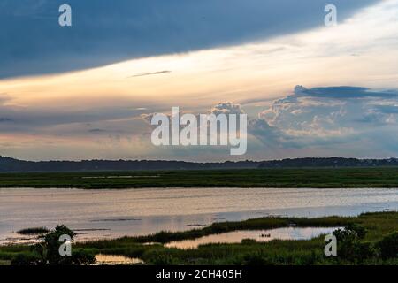 Incredible clouds glowing after a storm passes through the marshlands. Stock Photo