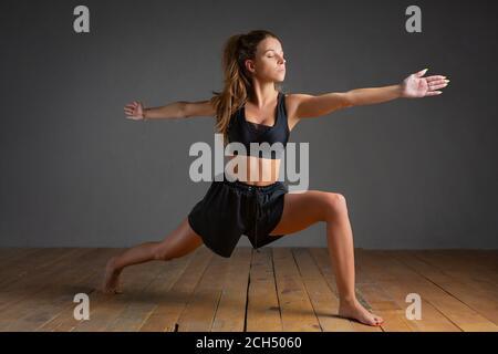 Man performs yoga asana Akarna Dhanurasana or Ardzhunasana Archer Pose or  Pose Arjuna on rug. 25767956 Vector Art at Vecteezy