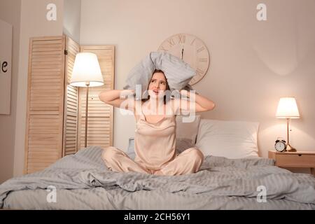 Stressed woman suffering from insomnia in bedroom Stock Photo