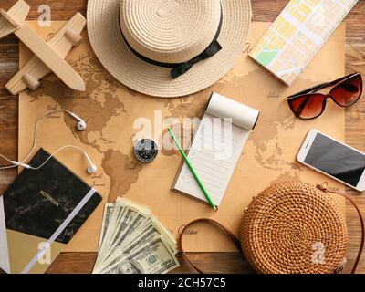 Notebook with check-list of things to pack for travel on world map Stock Photo