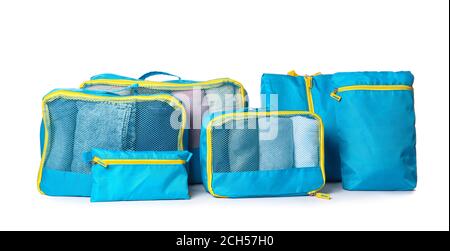 Travel organizers with clothes on white background Stock Photo