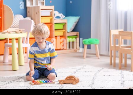 Cute little boy playing in kindergarten Stock Photo