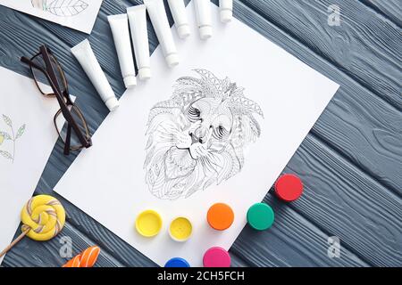 Composition with coloring pictures on table Stock Photo - Alamy