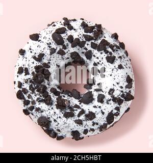 chocolate donut with white glaze isolated on pink background, close up. Stock Photo