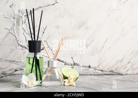 Different reed diffusers on table Stock Photo