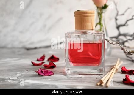 Reed diffuser on table against light background Stock Photo
