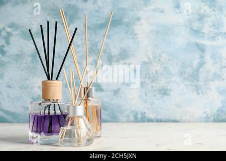 Different reed diffusers on table Stock Photo