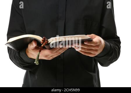 Handsome priest with Bible on white background, closeup Stock Photo