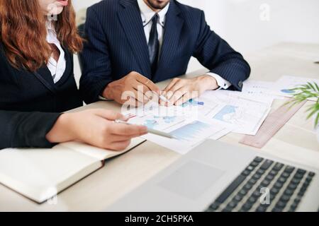 Financial analysts discussing documents Stock Photo