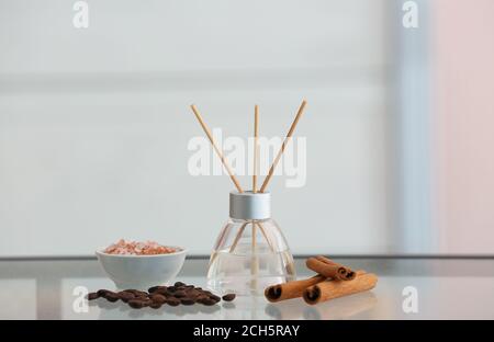 Reed diffuser, cinnamon, sea salt and coffee beans on table Stock Photo
