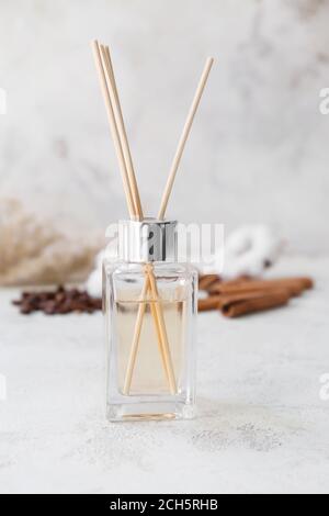 Reed diffuser, cotton, coffee beans and cinnamon on table Stock Photo
