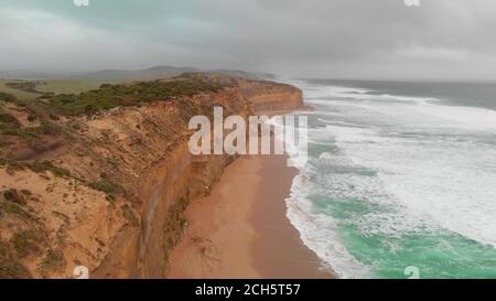 Amazing aerial view of Great Ocean Road cliffs on a coudy afternoon, Australia. Slow motion Stock Photo