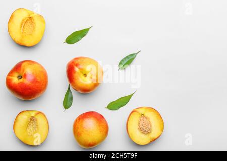 Sweet ripe nectarines on light background Stock Photo