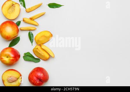 Sweet ripe nectarines on light background Stock Photo