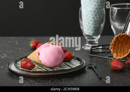 Plate with tasty strawberry ice cream on dark background Stock Photo