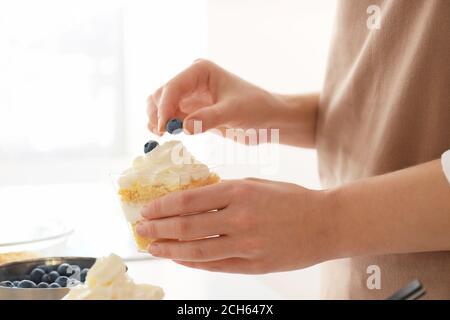 Woman preparing delicious cupcake in jar Stock Photo