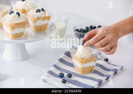 Woman preparing delicious cupcake in jar Stock Photo