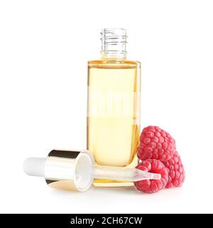 Bottle of raspberry essential oil on white background Stock Photo