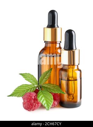 Bottles of raspberry essential oil on white background Stock Photo
