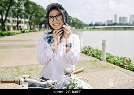 Chinese woman putting on helmet Stock Photo