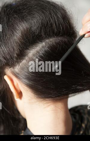 Closeup of combing back side hair part with selective focus Stock Photo