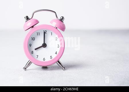 Pink alarm clock on on stone background. Copy space for text - Image Stock Photo