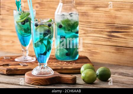 Glass of tasty blue mojito cocktail on wooden background Stock Photo