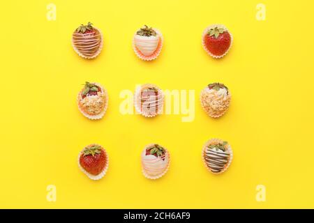 Tasty strawberry dipped in chocolate on color background Stock Photo