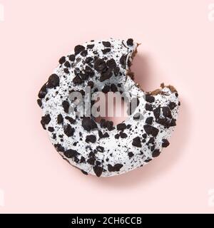 chocolate donut with white glaze isolated on pink background, close up. Stock Photo