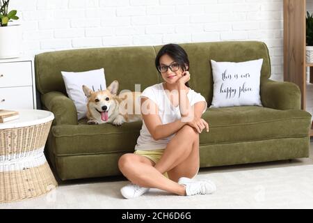 Woman with cute corgi dog at home Stock Photo