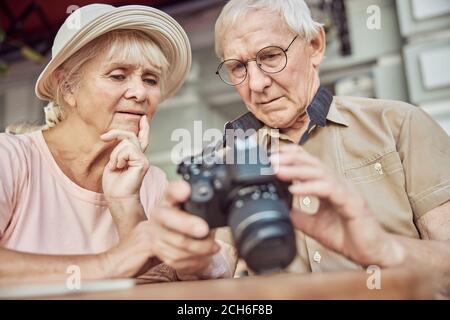 Puzzled aged people staring into the digital camera Stock Photo