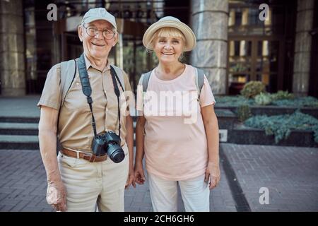 Smiling elderly tourists looking in front of them Stock Photo