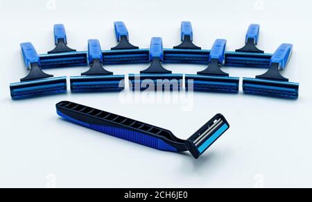 Blue razor with set of razors on background. Selective focus Stock Photo