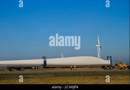 Wind turbine blade being delivered by truck to wind farm construction site for Sacramento Municipal Utility District, near Rio Vista California. Stock Photo