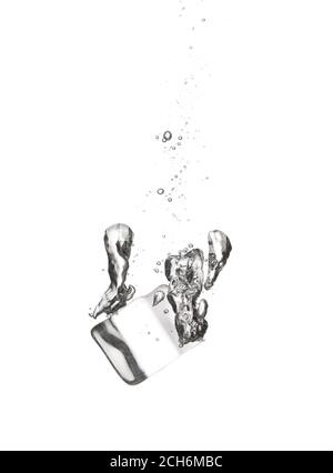 Falling of ice cube into water on white background Stock Photo