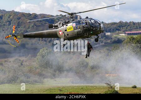 Soldiers ben air rescue by Austrian helicopter  Aérospatiale Alouette III during Military Exercise “Quick Response 2016” in Bosnia Stock Photo