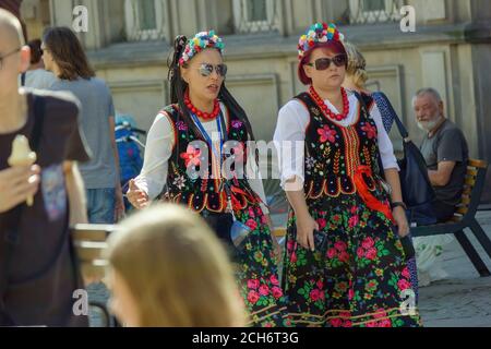 Gdansk, North Poland - August 14, 2020: Couple of women dressed up in polish traditional dress walking in the old town during dominic's fair in August Stock Photo