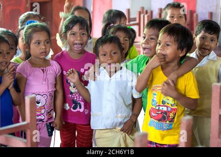 A group of children singing at the primary school in the Amazon River town of Indiana in Peru. Stock Photo